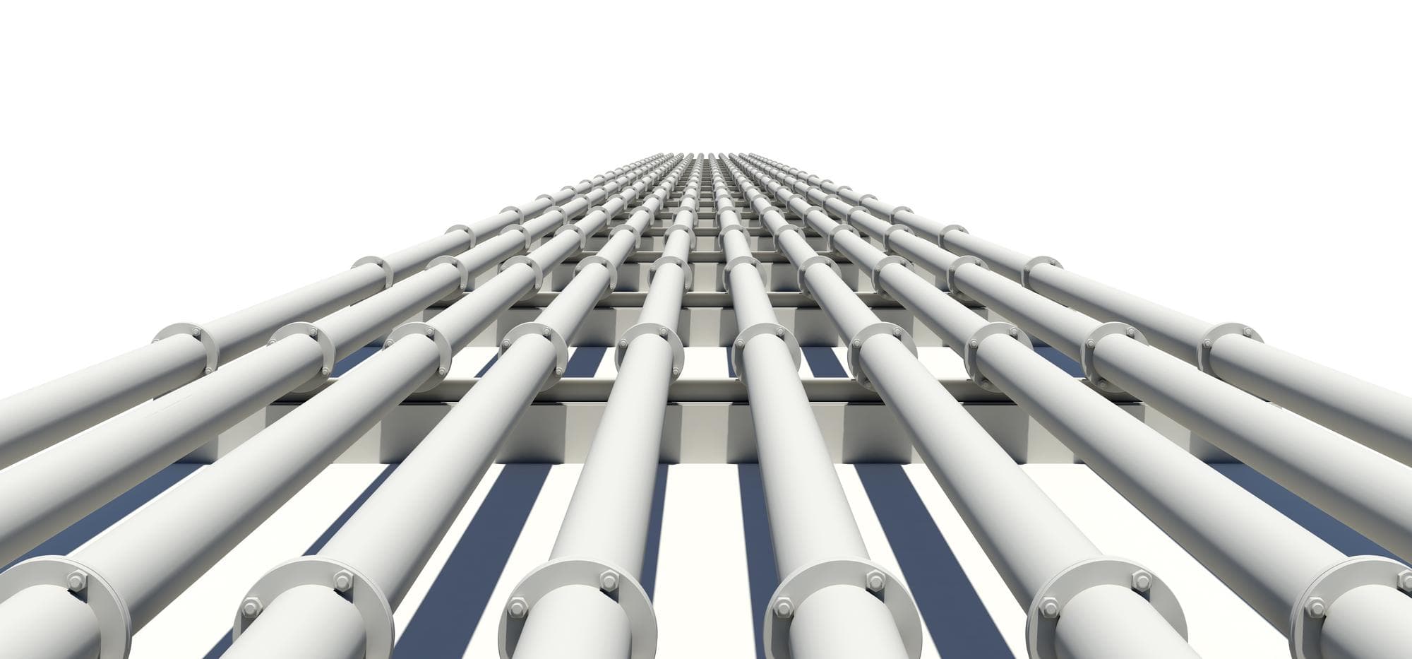 Four parallel pipes converging into a single industrial junction, shallow focus