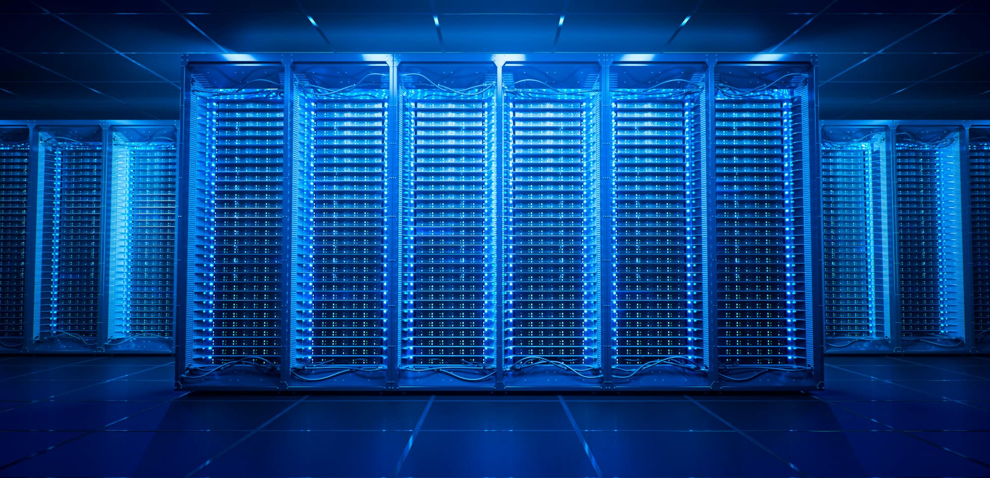 Rows of server racks in a blue-lit data centre with cabling and status LEDs