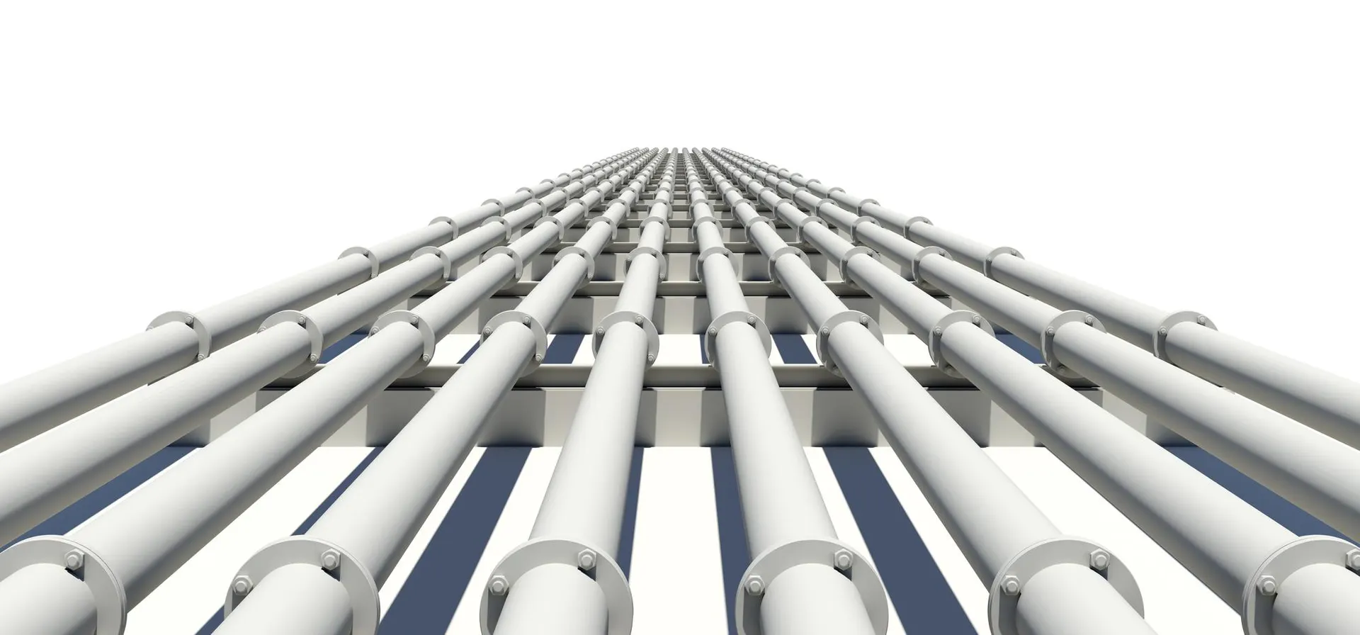 Four parallel pipes converging into a single industrial junction, shallow focus