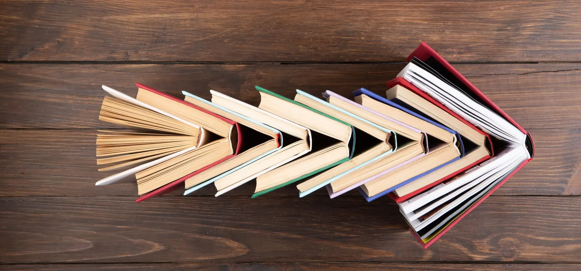 Books arranged in an arrow shape against a soft library backdrop, conveying directed retrieval against a large reference corpus